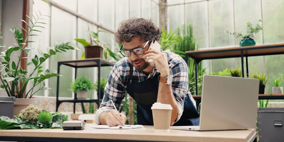 man talking on phone in a plant shop