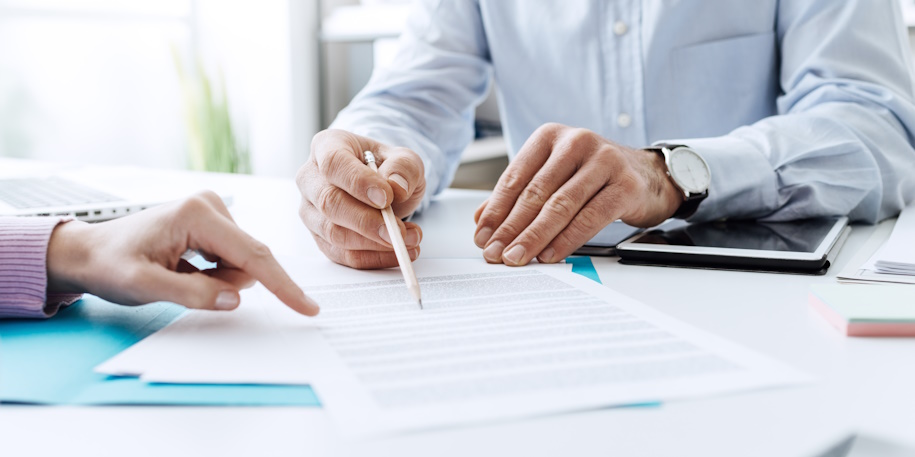 people reviewing a document at a desk