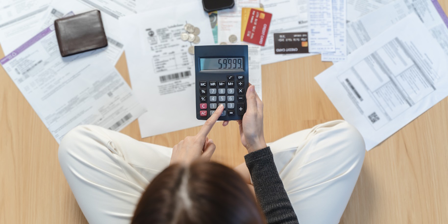 woman calculates debt with a calculator